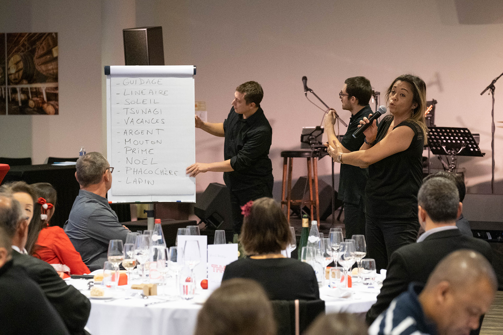 Corporate dinner Liege La Boverie pavilion seated tables evening · INNOV'events